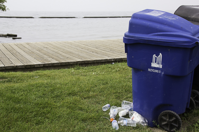 A recycle bin overflows on the beach in Toronto’s west-end. Photo credit: Cristina Bergman
