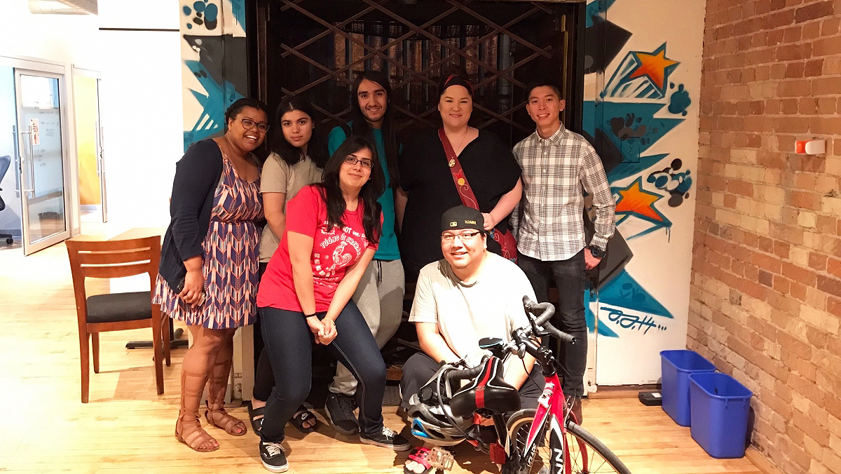 A group of Youth Cabinet members pose in front of a graffiti wall the Wattpad office with Lindy Kinoshameg and Wattpad's Talent Manager I-Yana Tucker in 2018.